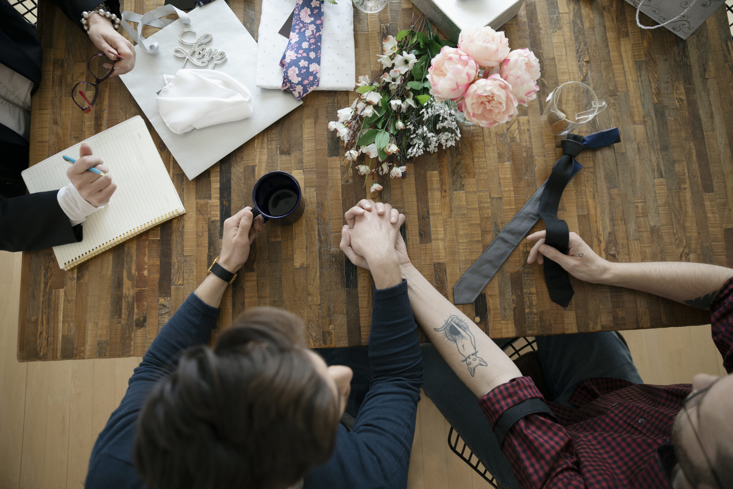 Couple holding hands as they plan how to pay for their wedding