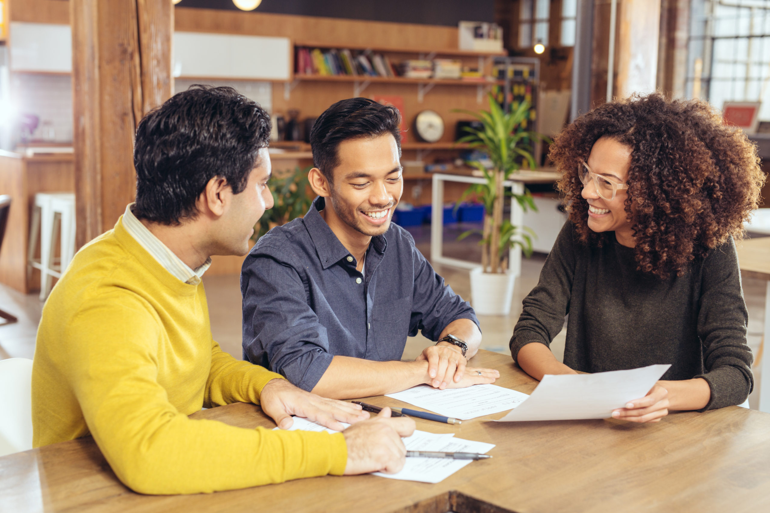 gay couple looks over mortgage documents