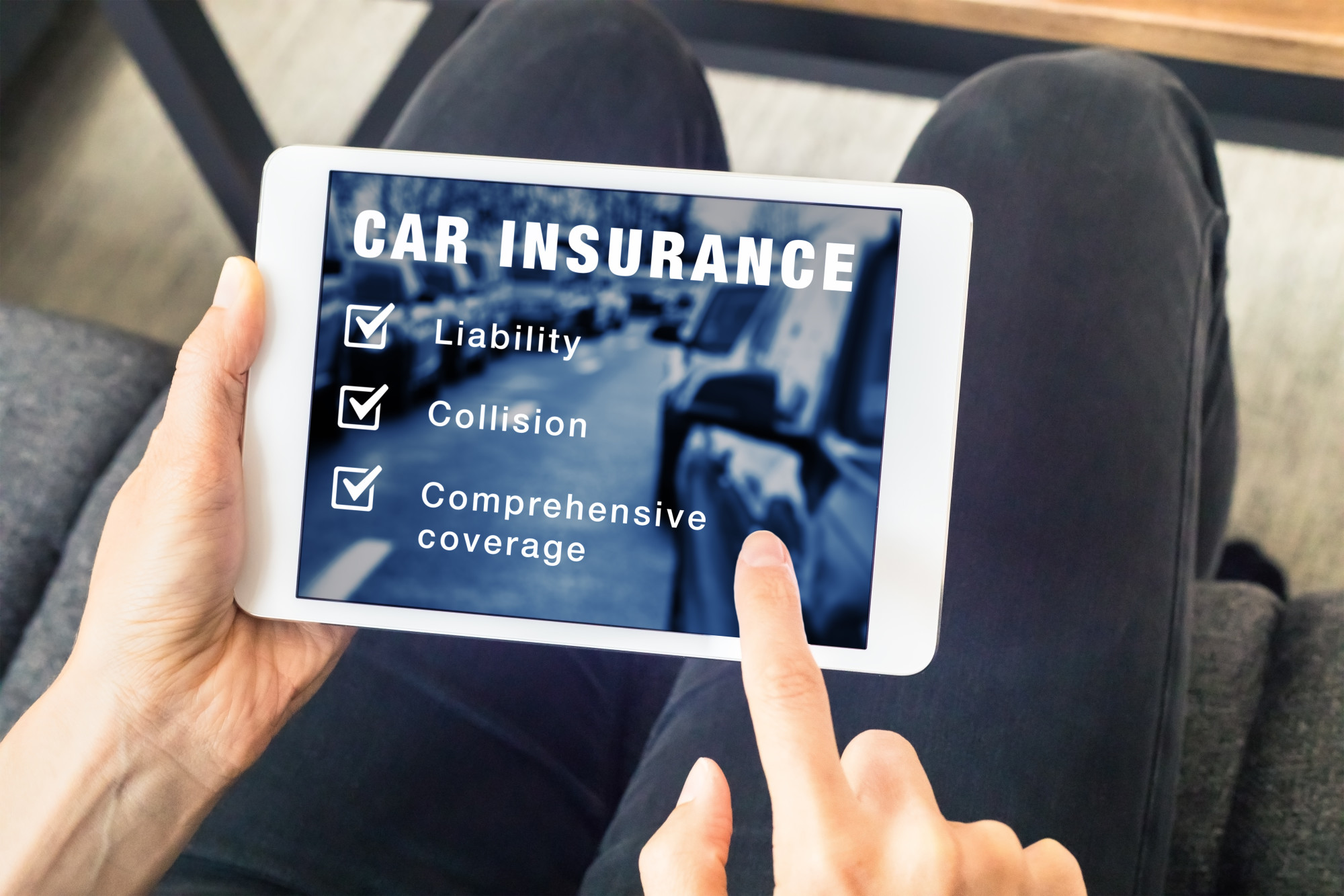 Person choosing car insurance coverage options (liability, collision, comprehensive) on website on digital tablet computer screen, vehicle and risk protection