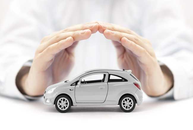 hands covering a car figure