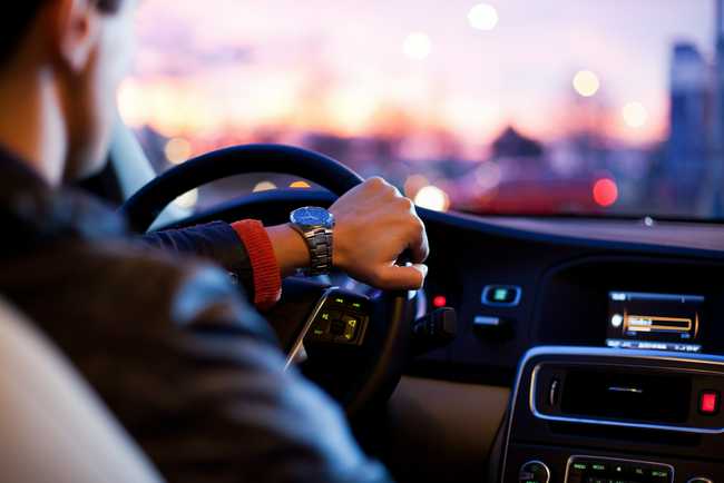 Photo of hand on steering wheel