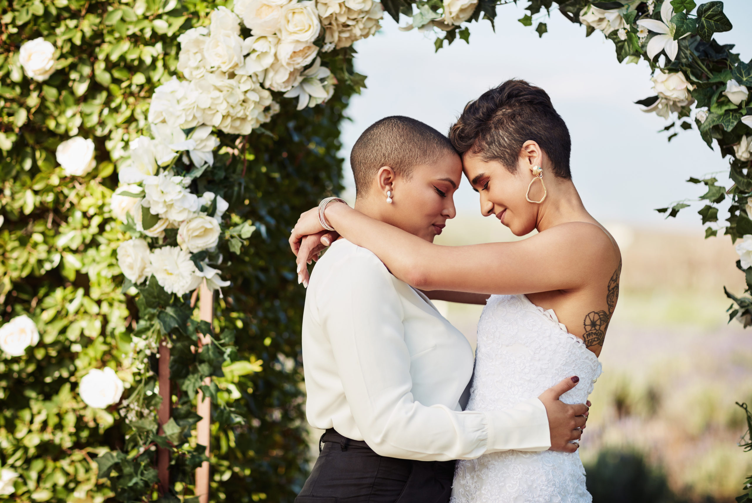 Lesbian couple getting married in a civil ceremony or courthouse wedding during the coronavirus pandemic and Pride month