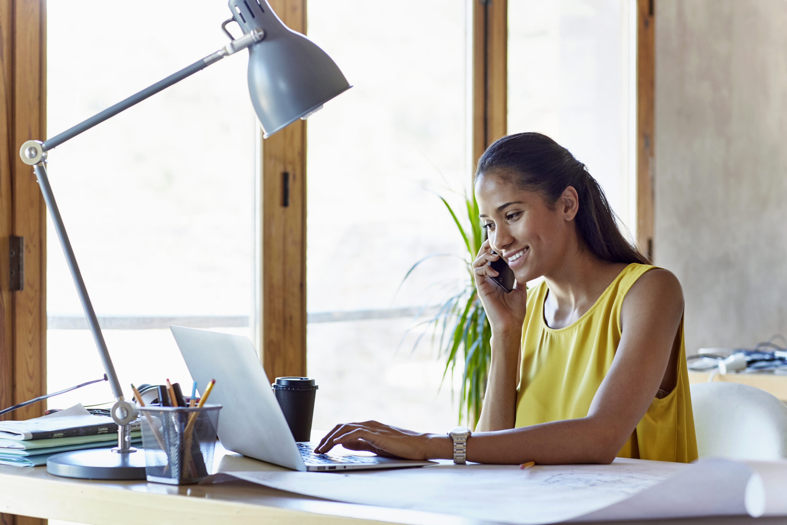 A woman on the phone with her mortgage underwriter