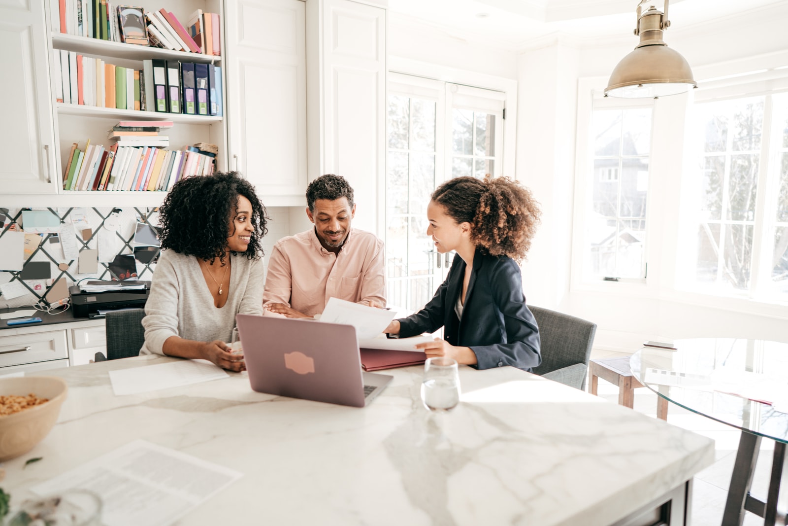 A couple reviewing title insurance documents with an advisor