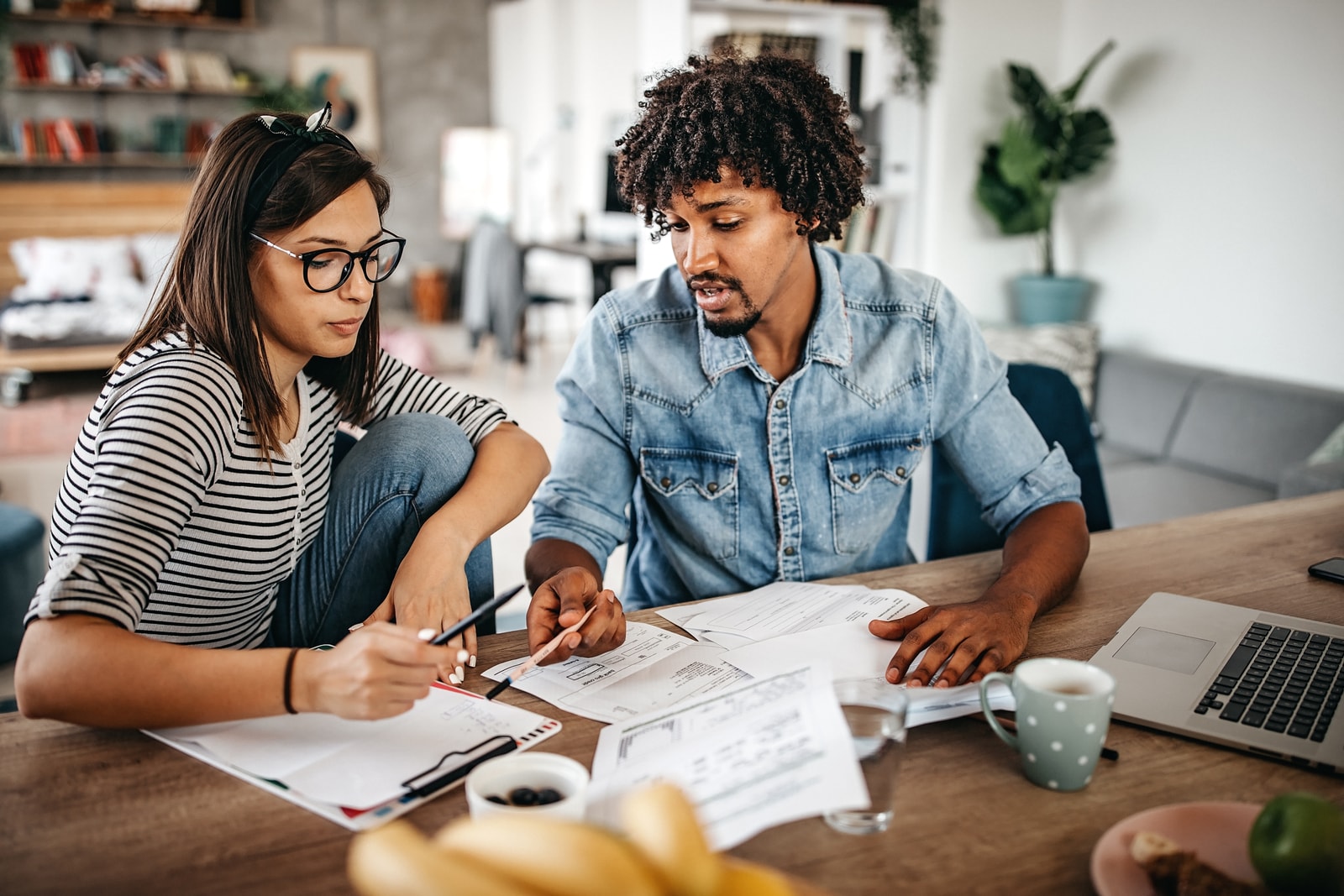 a young couple reviewing their finances for 2020 and making goals for 2021