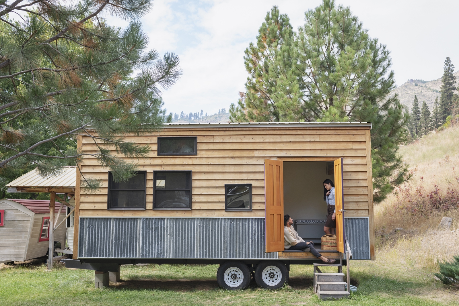 couple discussing tiny house pros and cons before buying a tiny home