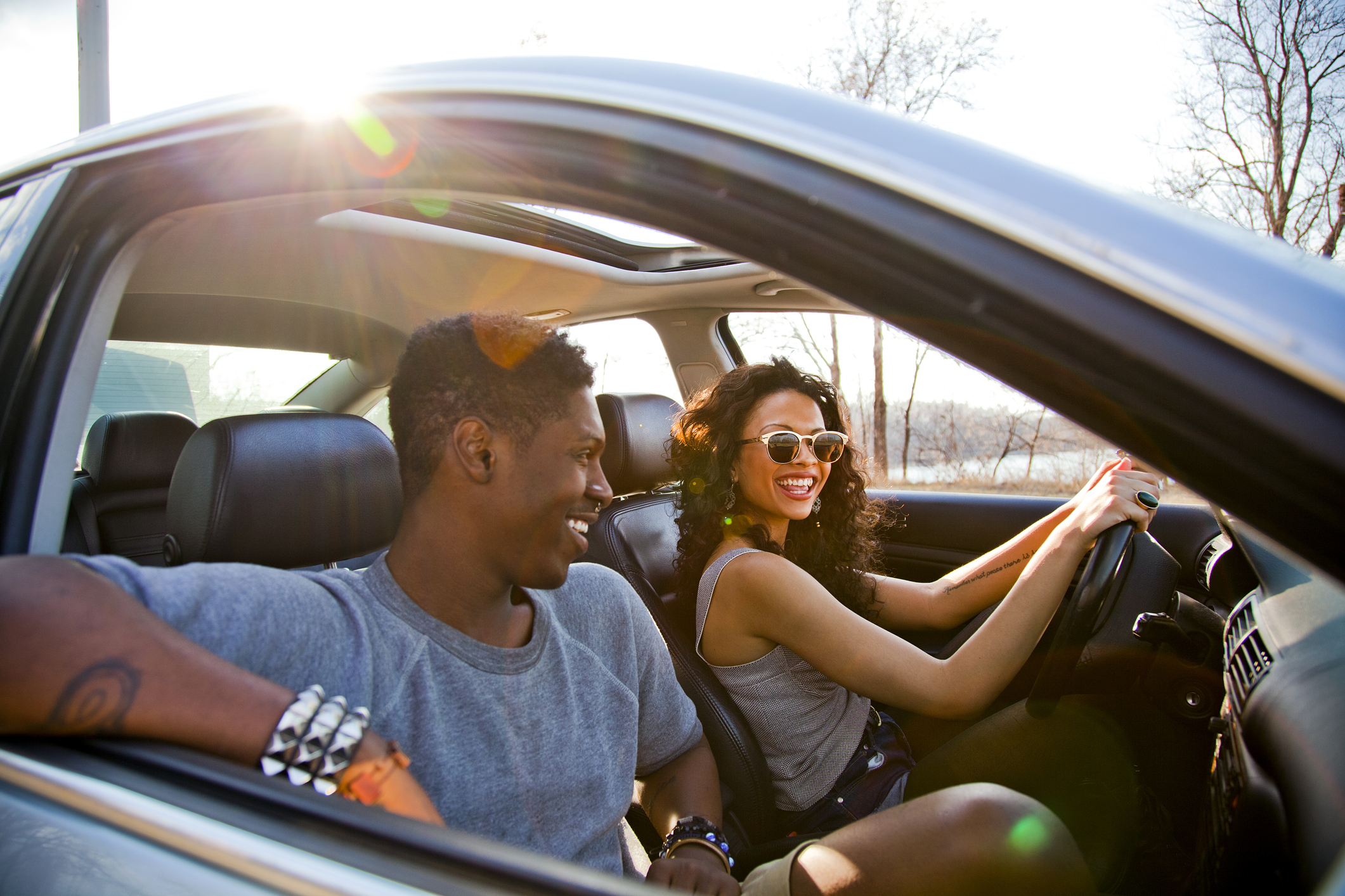 happy couple after learning ways to save money on car insurance