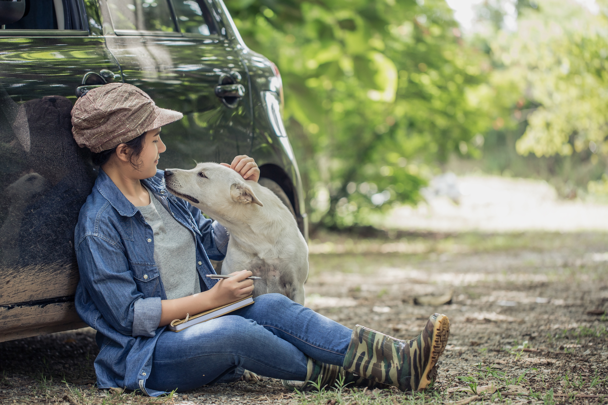 Woman with her dog next has auto insurance