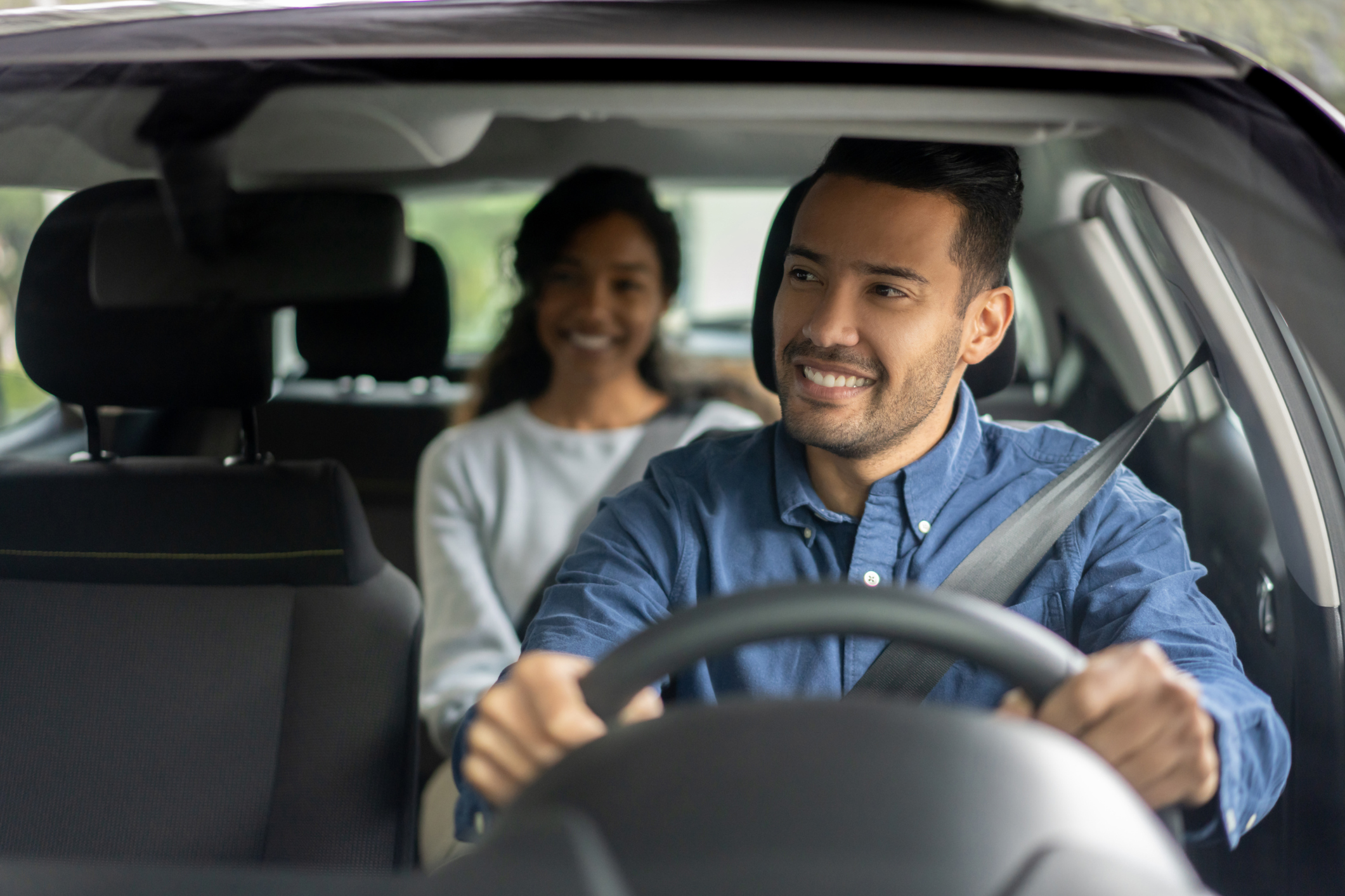 Rideshare driver with customer in the backseat